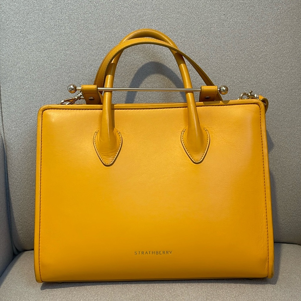 The Strathberry Midi Tote, wear and tear on the corners. Very clean inside.
